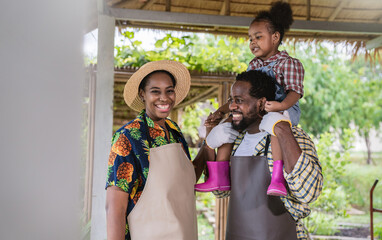 Wall Mural - Portrait of happy sme owner black African American farmer family working in barn farm, worker planting in organic nersery, startup small business owner, lifestyle mother father farmer job concept