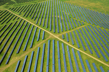 Aerial texture view with a big solar panel plant on top of the hills. Summer industrial landscape with a plant that produce electricity from the sunlight. Green eco energy industry.