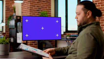 Poster - Corporate worker typing on computer with greenscreen monitor, working with blank chroma key display and isolated copyspace template. Using desktop pc with mockup background on screen.