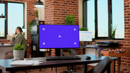 Poster - Empty office desk with greenscreen display on computer desktop, isolated chroma key background with mockup template. Monitor with blank screen used by business people in startup office.
