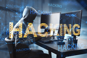 Canvas Print - Cyber attack and hacking concept with faceless hacker in hoody in front of computers and glowing digital yellow hacking word, double exposure