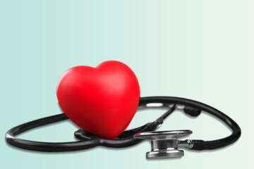 Poster - Red heart shape hand exercise ball with doctor physician's stethoscope. World heart health day. doctor day, world hypertension day