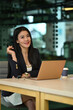 © Prathankarnpap - Portrait of confident asian female manager sitting with laptop computer in office and smiling to camera