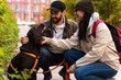 © NFstock - Full length view of the happy spouses relaxing in autumn landscape with their brown dog. Man and woman stroking their Labrador