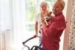 Happy elderly woman with a small dog as a pet