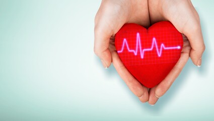 Canvas Print - World Hypertension Day. Adult holds a red heart with a heartbeat chart, a symbol of high blood pressure.