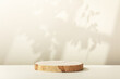 © Natalia Klenova - Wood slice podium with leaves  and window shadows on beige background for cosmetic product mockup