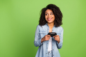 Wall Mural - Photo of young adorable girl wonder look empty space player gamer joystick isolated over green color background