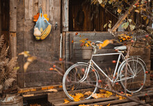 Vintage Bicycle Leaning On Wooden Wall Of Old Atmospheric Country House On Beautiful Autumn Day
