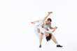 © Lustre Art Group  - Portrait of young cheerful couple, man and woman, dancing swing isolated over white studio background