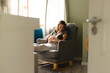 © Wavebreak Media - Happy caucasian mid adult mother breastfeeding newborn baby while sitting on armchair at home