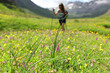 © Antonioguillem - Blurred hiker walking and flower in foreground