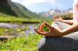 © Antonioguillem - Close up of a woman hands doing yoga in nature