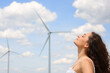 © Antonioguillem - Profile of a woman breathing fresh air in a wind farm
