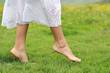 © Antonioguillem - Woman bare feet walking on the grass in the mountain