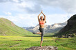 © Antonioguillem - Yogi in a high mountain field doing yoga