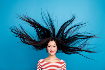 Photo of lovely funny lady dressed red shirt hair flying wind blowing isolated blue color background