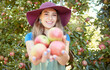 © Jade M/peopleimages.com - Portrait of one happy young woman holding freshly picked red from trees on sustainable orchard farmland outside on sunny day. Farmer harvesting juicy nutritious organic fruit in season ready to eat