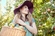 © Jade M/peopleimages.com - Cheerful farmer harvesting juicy nutritious organic fruit in season to eat. A happy woman from below holding basket of freshly picked apples from tree on sustainable orchard farm outside on sunny day