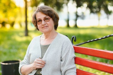 Poster - Portrait of a happy Senior woman in summer park