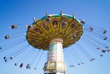 Volgograd, Russian Federation, June 19, 2022 - Swing carousel in an amusement park on the Volga River embankment. 
