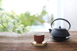 earthenware tea cup and tea pot on wooden table outdoor relaxation drinking