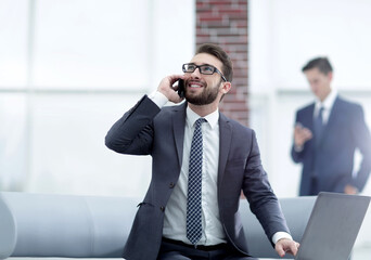 Wall Mural - Confident young man talking on phone in office