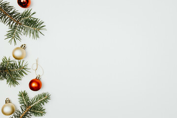 Wall Mural - fir branches christmas balls on a white background top view.