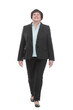 © ASDF - Mature business woman in a pantsuit striding forward.