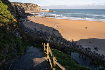 Beautiful landscape of the picturesque beach of Langre surrounded by cliffs en un soleado día con el cielo azul, Langre, Cantabria, Spain