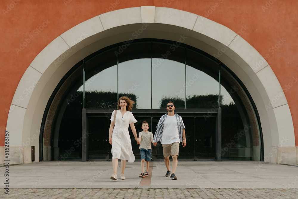 Dad Arch Father, mother and son are strolling from the arch in an old European ...