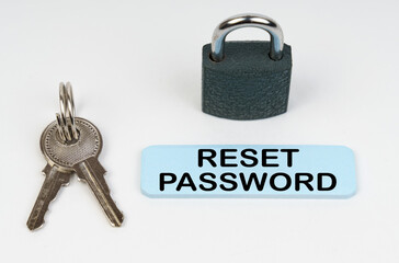 Poster - On a white surface there is a lock, keys and a blue sign with the inscription - Reset password