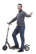 © ASDF - in full growth. casual young man with an electric scooter.