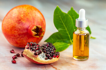 Wall Mural - Pomegranate oil in a cosmetic bottle with a pipette. Natural cosmetics and face care.