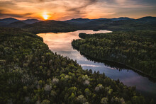 Aerial View Of Remote Mountain Lake At Sunset Deep In Maine Woods