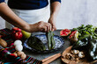 © Marcos - mexican woman hands peeling poblano chillies pepper for cooking chiles en nogada traditional dish in Puebla Mexico