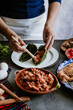 © Marcos - mexican woman hands preparing and cooking chiles en nogada recipe with Poblano chili and ingredients, traditional dish in Puebla Mexico