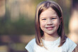 © R - Happy little girl outdoors close up portrait