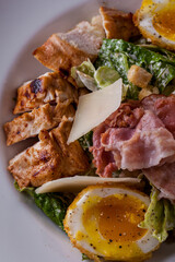 Salad with meat, bacon, boiled egg