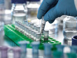 © Connect Images - Close-up of scientists gloved hand holding pipette in lab