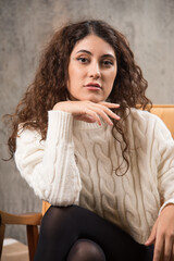 Photo of attractive lady sitting in comfy chair and posing