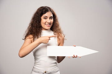 Young woman holding empty blank white speech poster