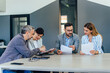 © bnenin - Group of business people, sitting together, working.