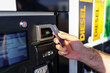© josemiguelsangar - Hand of a man paying by card at a fuel pump of a gas station at high prices.