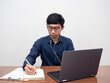 © Thanasak - Glasses man working at his workspace,Man writing on notebook working white background