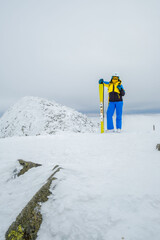 Wall Mural - woman skier posing on the top of snowed mountain