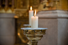 Burning White Candle On A Golden Stand In A Church