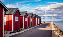 Red Boat Houses In Line In Bastad Harbor, Sweden
