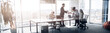 © Yaroslav Astakhov - People standing near table, team of young businessmen working together in office. Blurred background