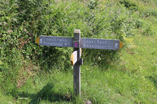 Wooden Sign Marking The Coastal Path Between Minehead And Bossington